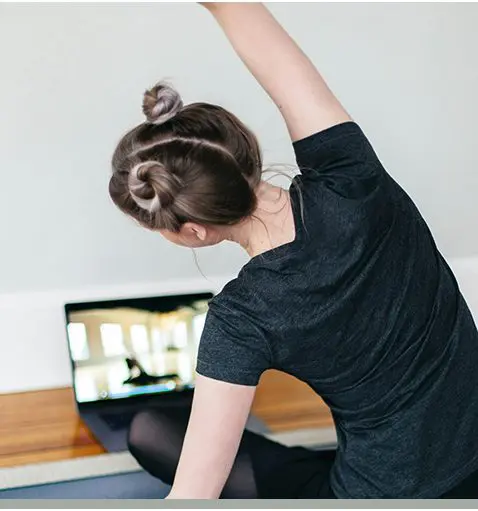 A woman is doing yoga on the floor