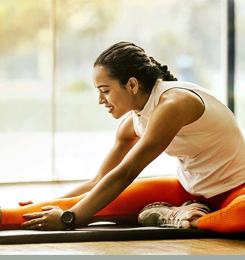 A woman is doing yoga on the floor